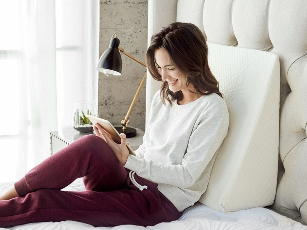 Woman resting against a back pillow