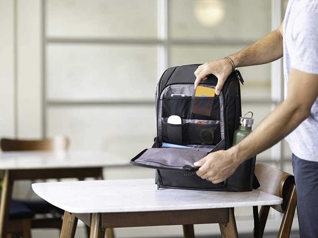 Man packing a laptop backpack.