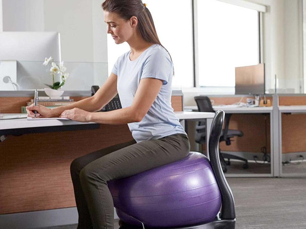 Woman sitting on a ball chair.