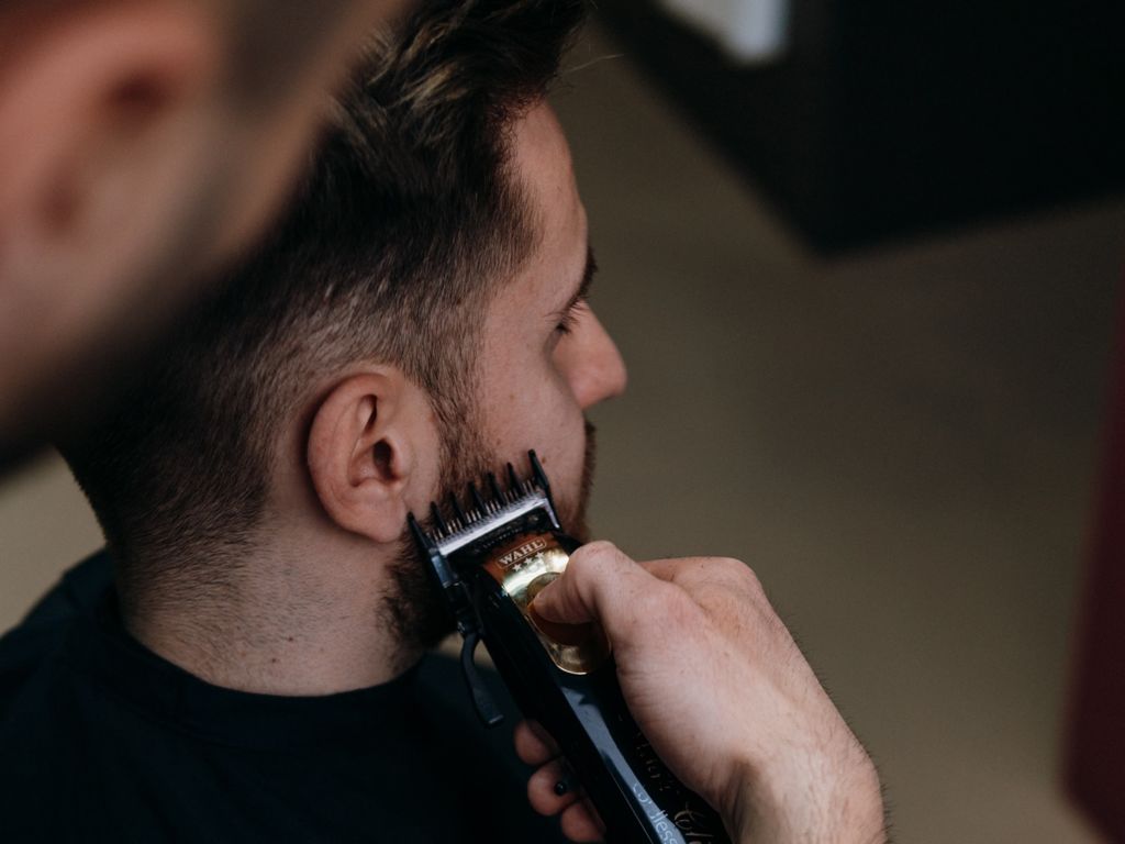 Man getting beard trimmed