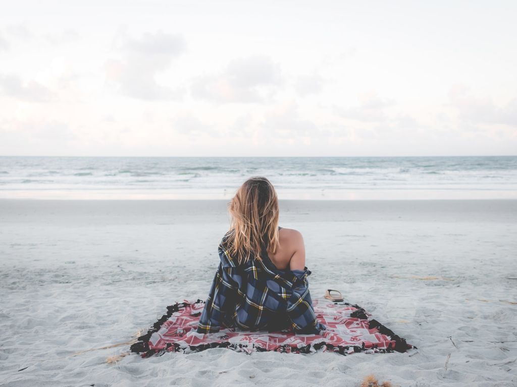 Woman relaxing on a beach blanket