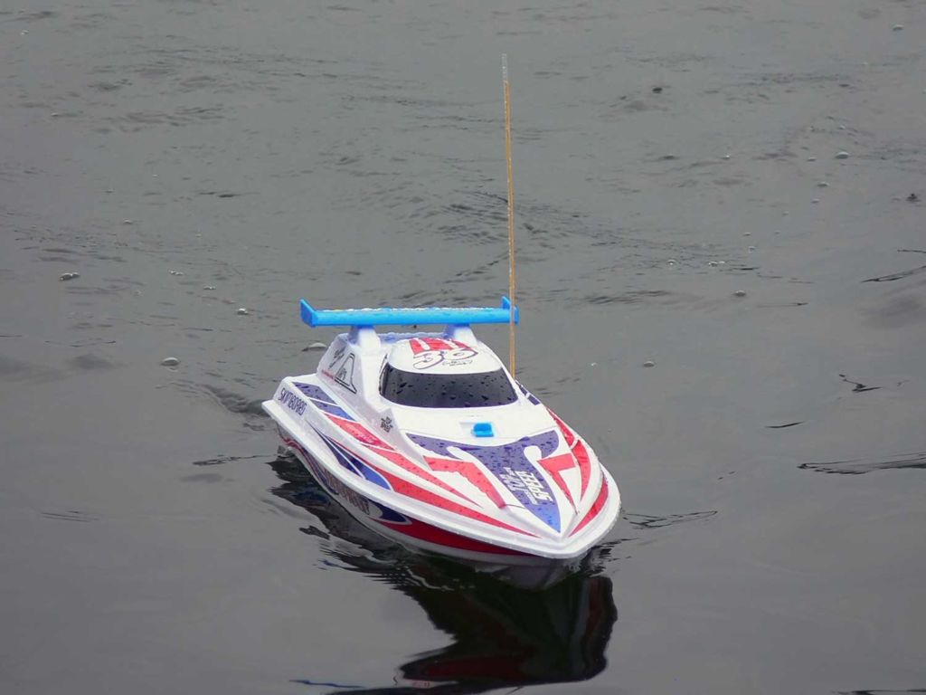 Remote-controlled boat on a body of water.