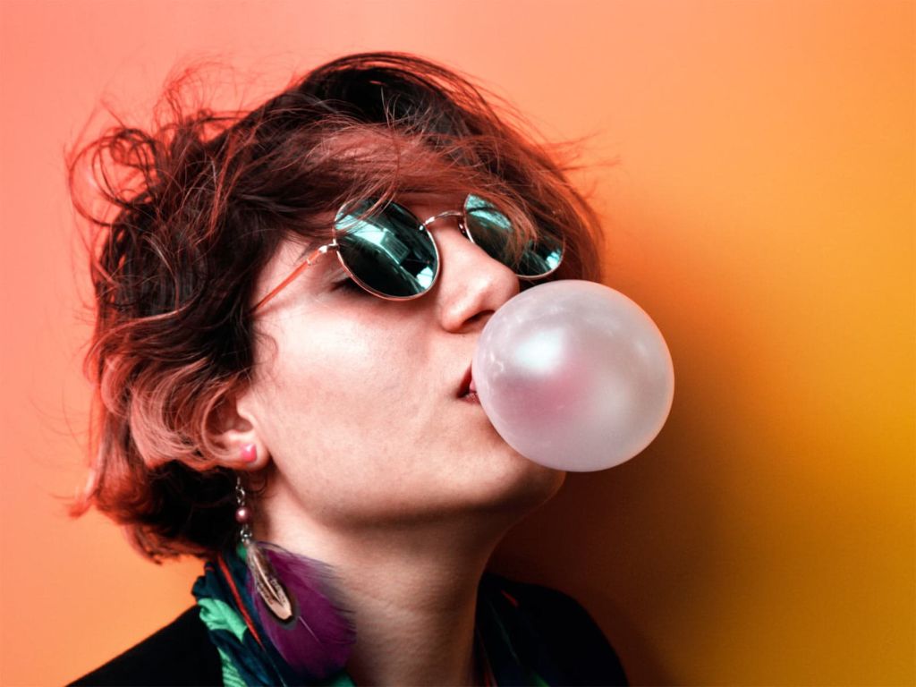 Woman blowing bubbles with chewing gum