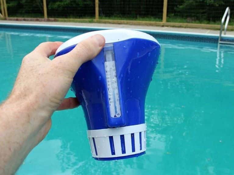 Man holding a pool chlorine dispenser.