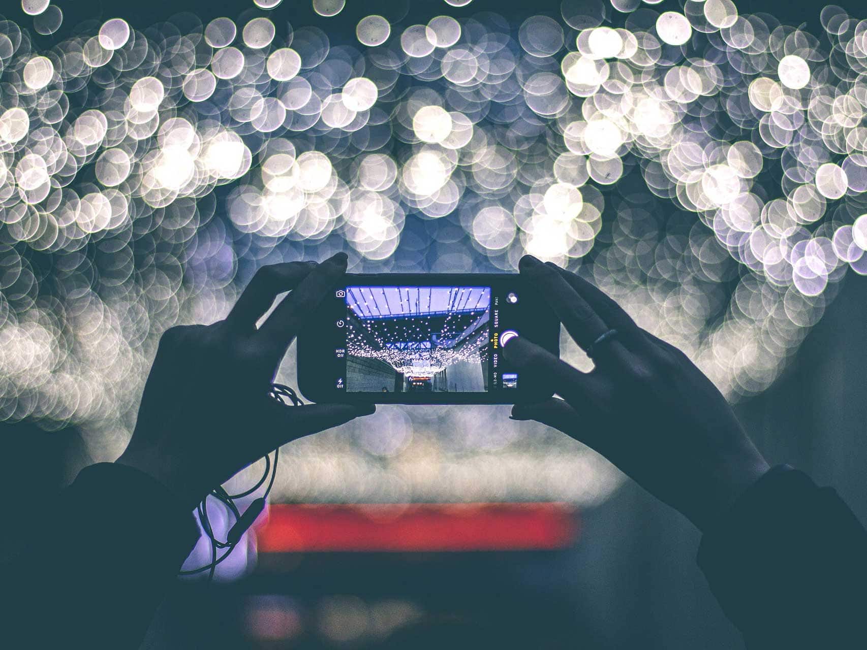 person taking a photo of lights