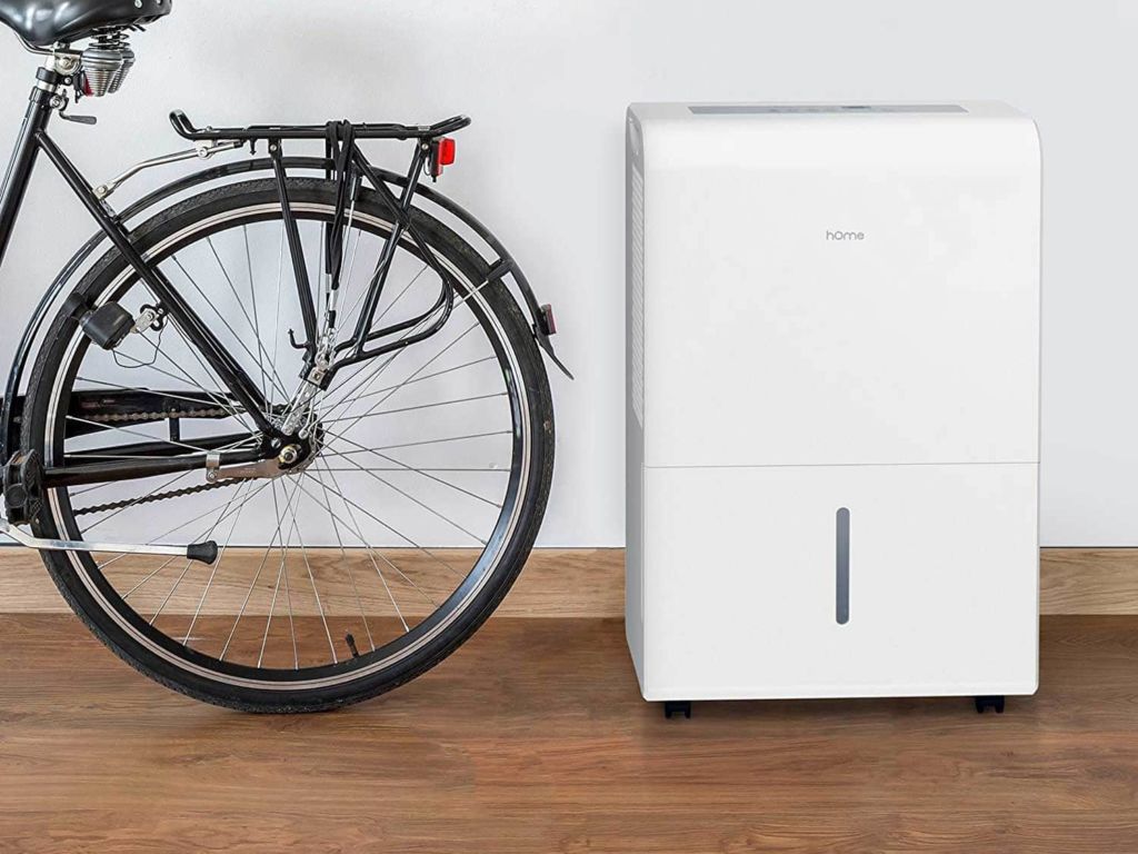 Bike resting near a dehumidifier.