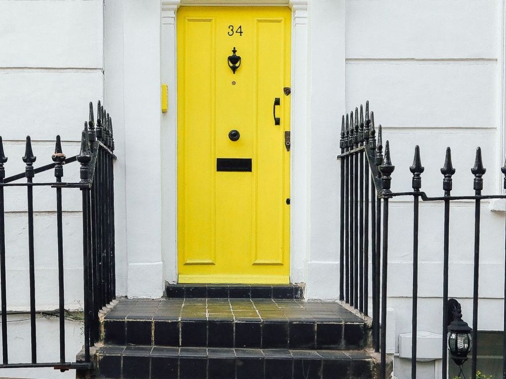 Yellow door with a door draft.