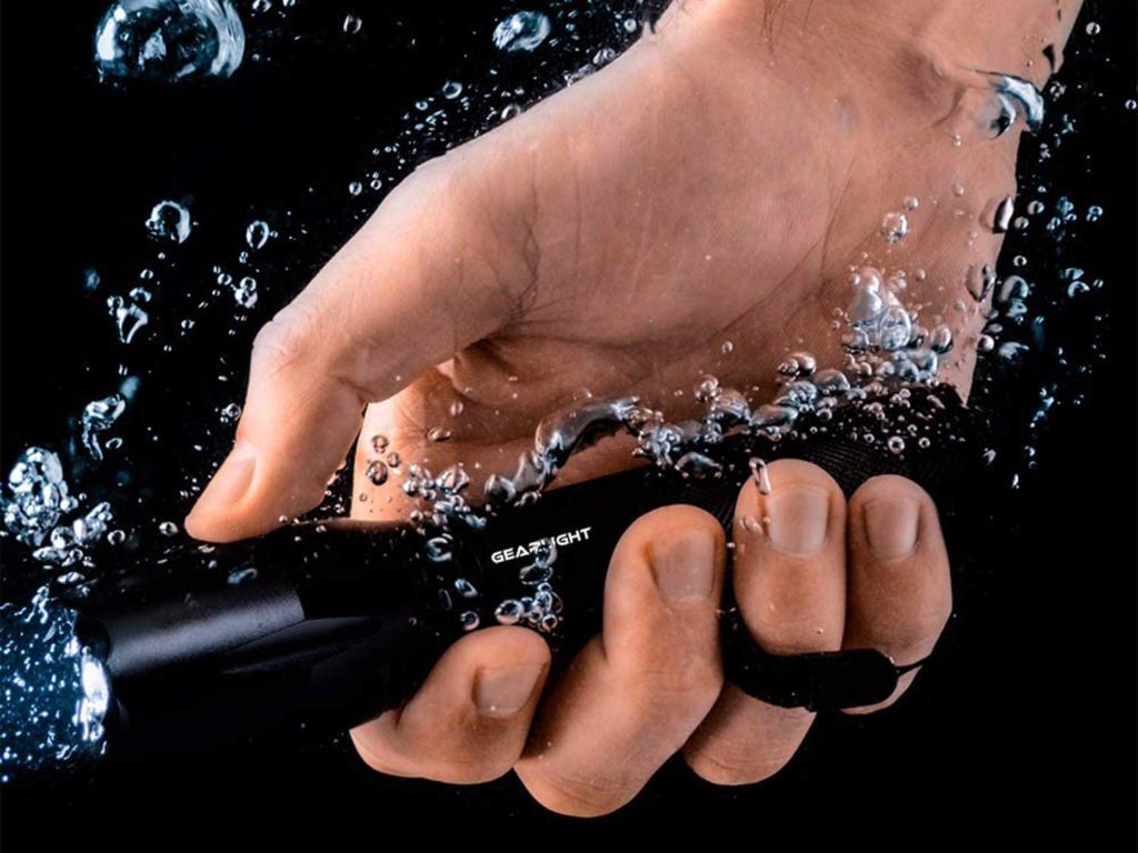 Man holding flashlight underwater