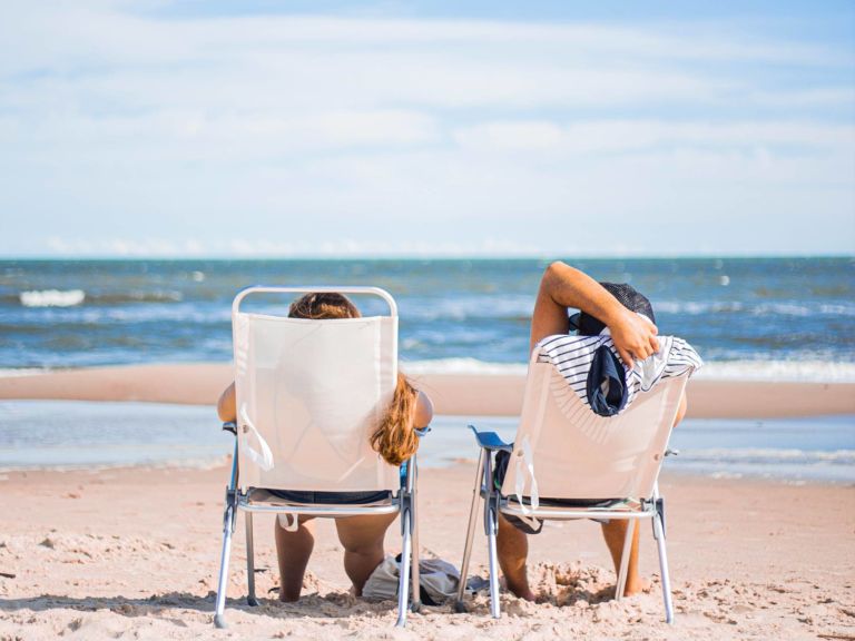 Two people in beach chairs