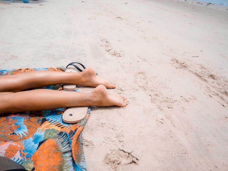 Person sunbathing on the beach