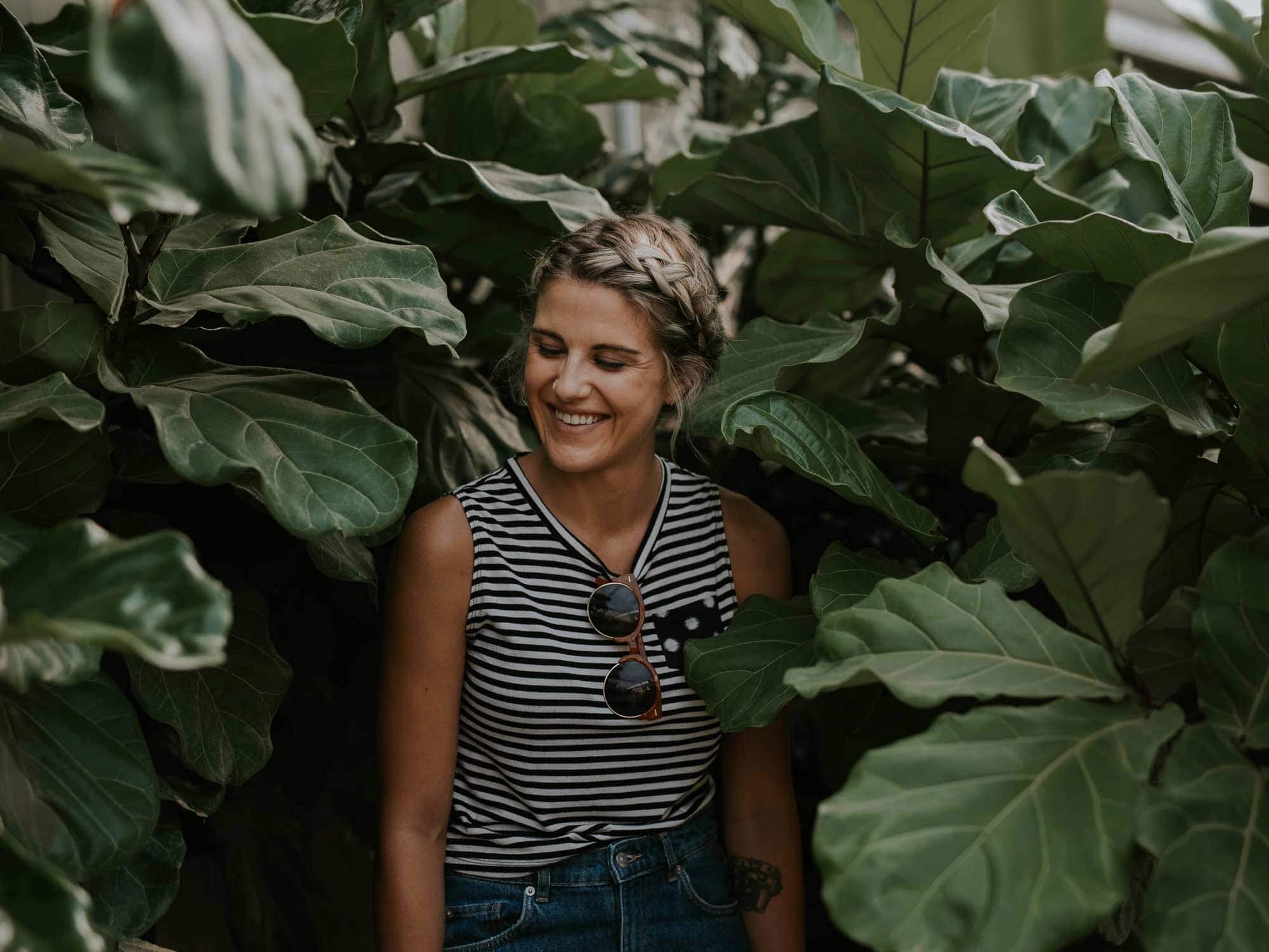 Woman smiling walking through plants