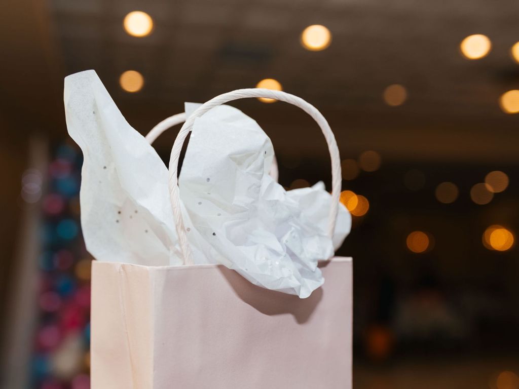 A white gift bag with tissue paper