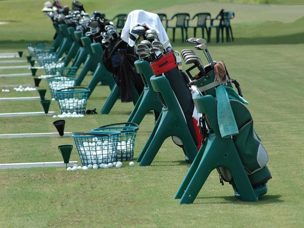 Golf bags at a driving course
