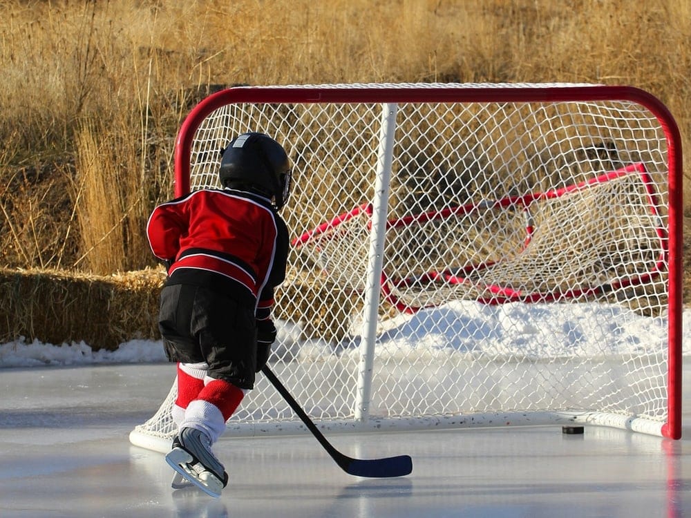 Kid playing hockey in cold weather