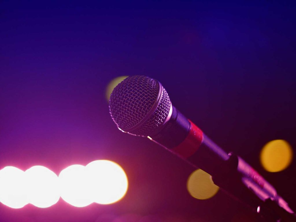 Karaoke microphone on a lighted stage.