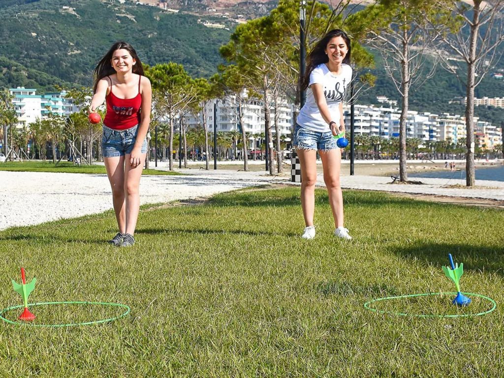 Two girls playing lawn darts