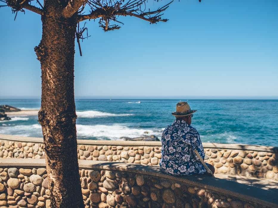 Male looking out at the ocean waves