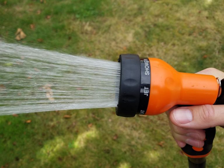 Man using a hose nozzle