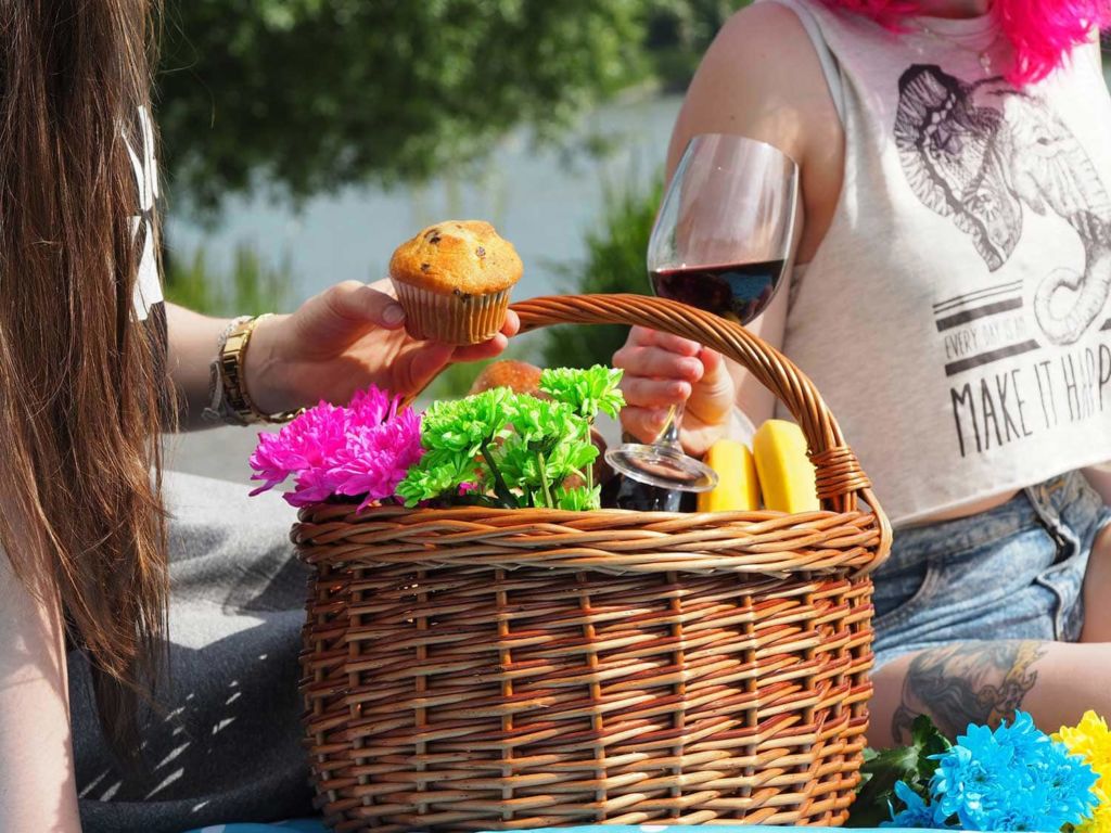 Two people enjoying a picnic basket
