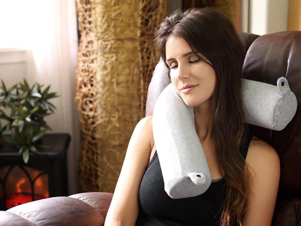 Woman napping with a travel pillow
