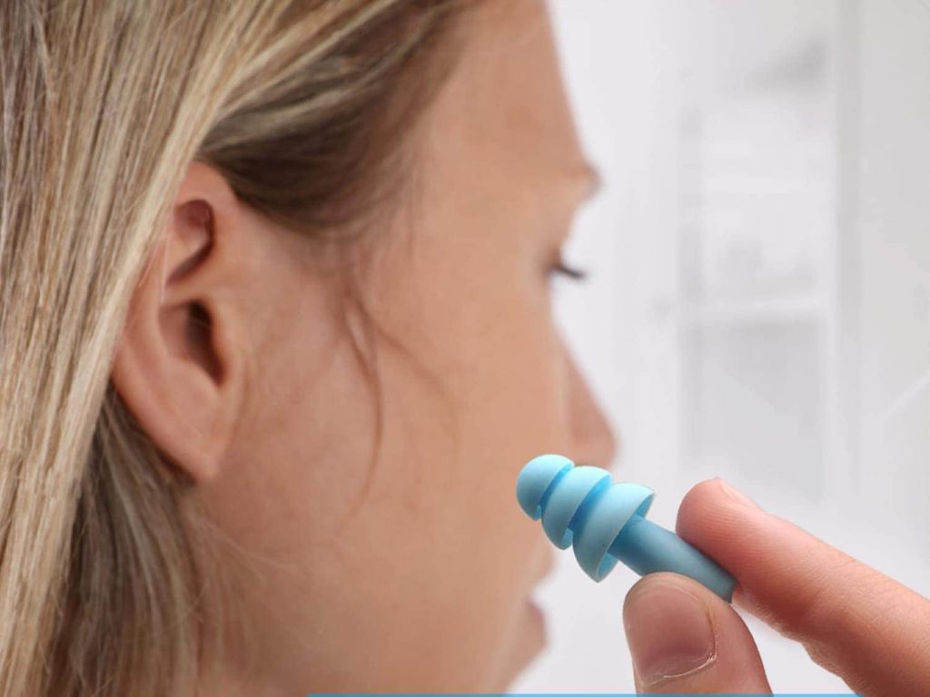 Woman holding an earplug