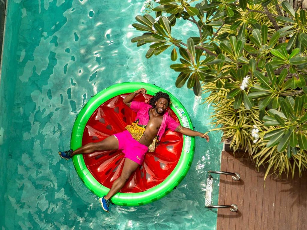 Man floating on a watermelon slice float.