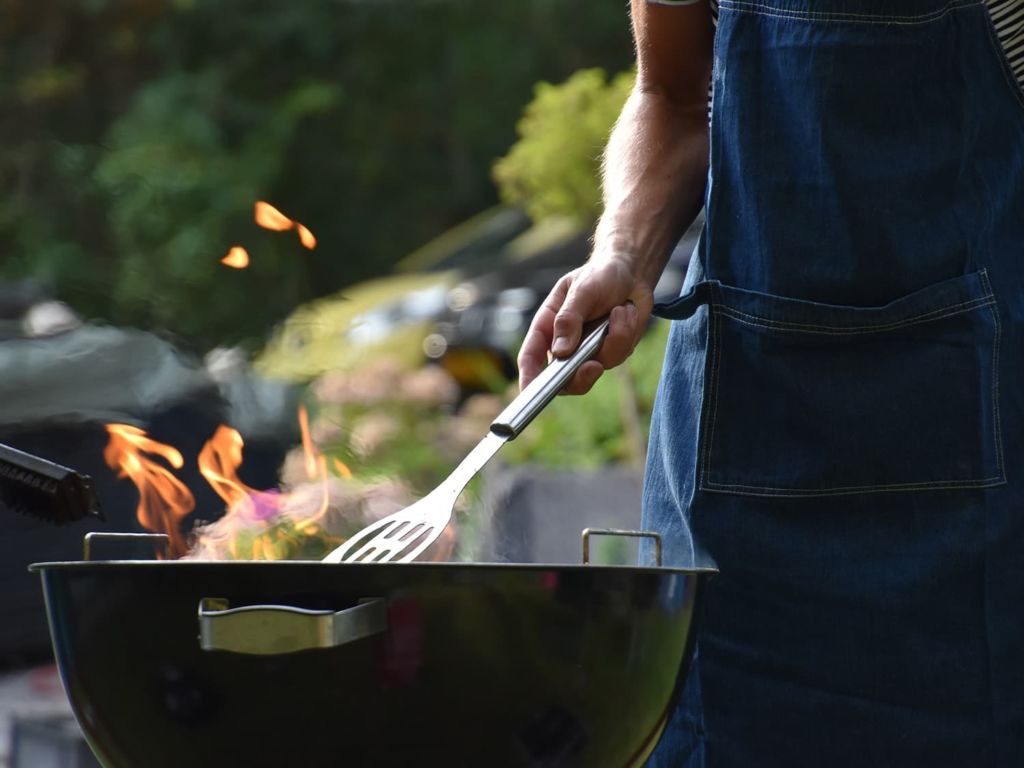Man using a portable grill to cook