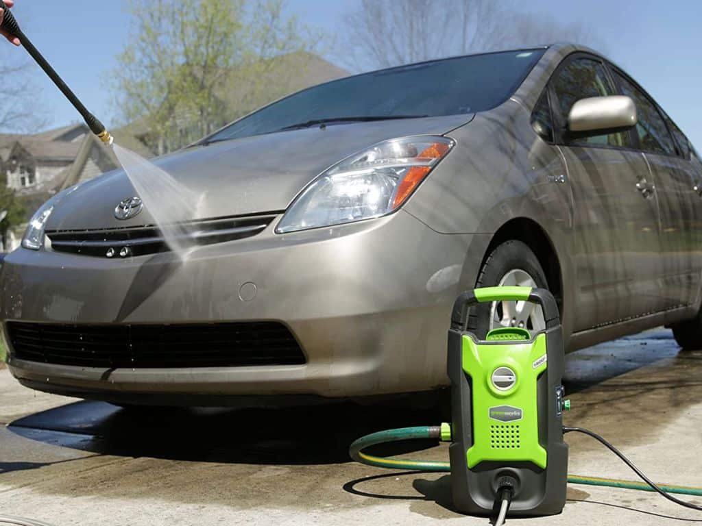 Man washing car with pressure washer