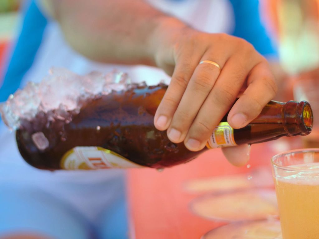 man pouring a beer