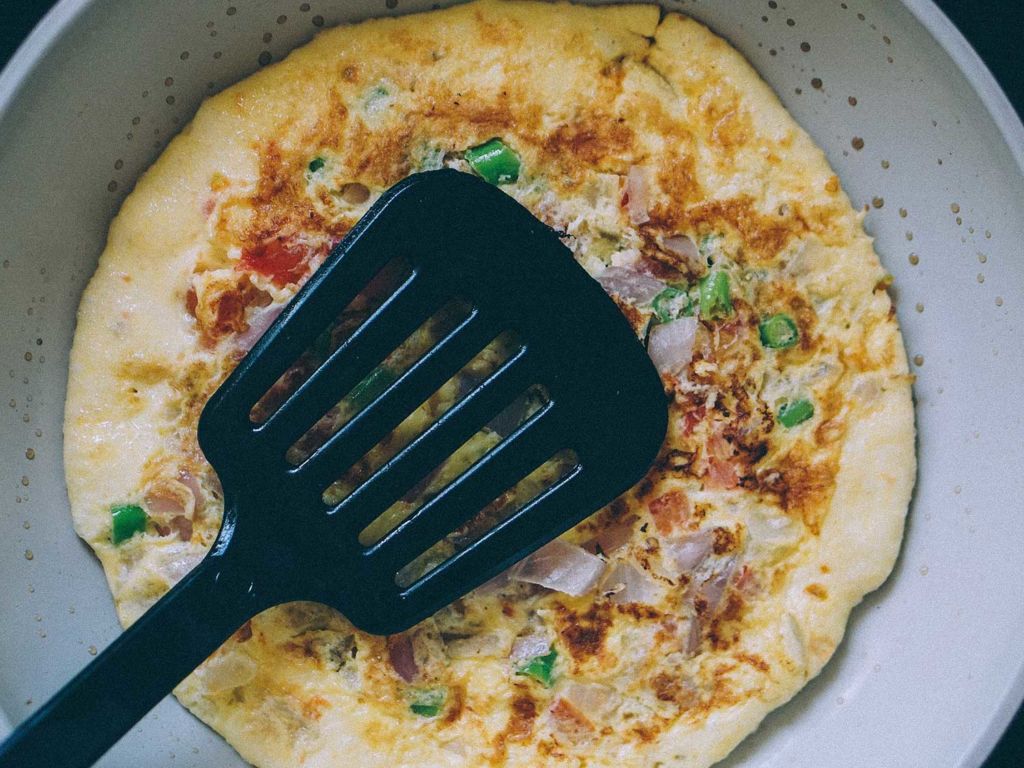 a spatula on top of an omelette