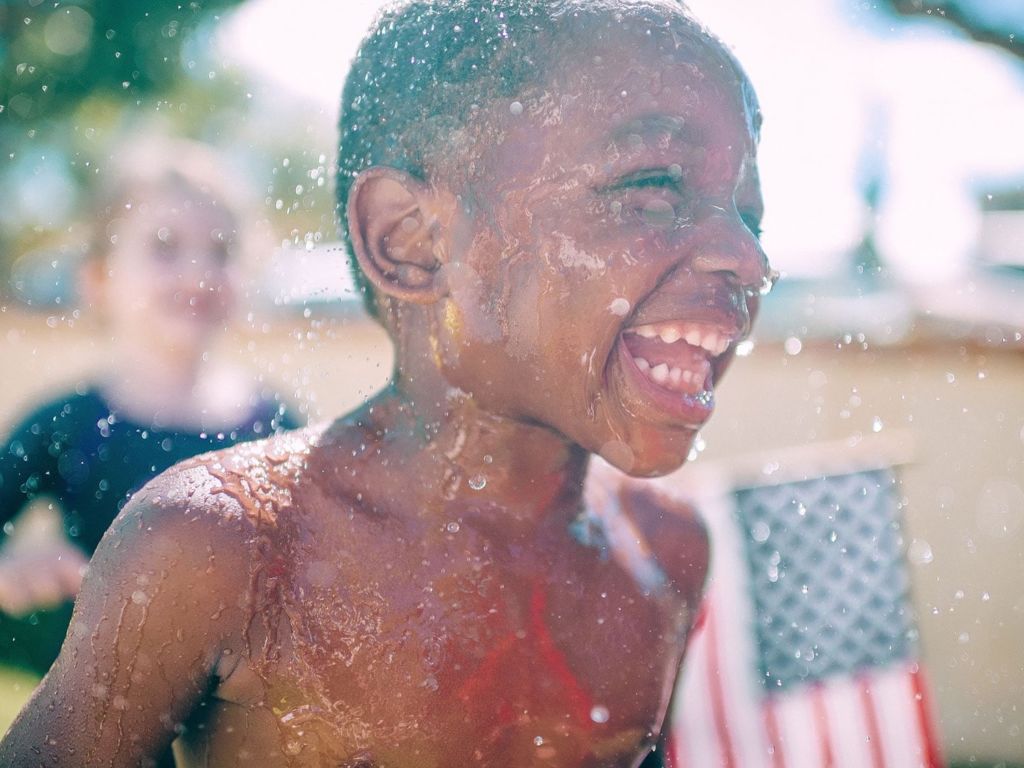 Smiling kids in sprinklers