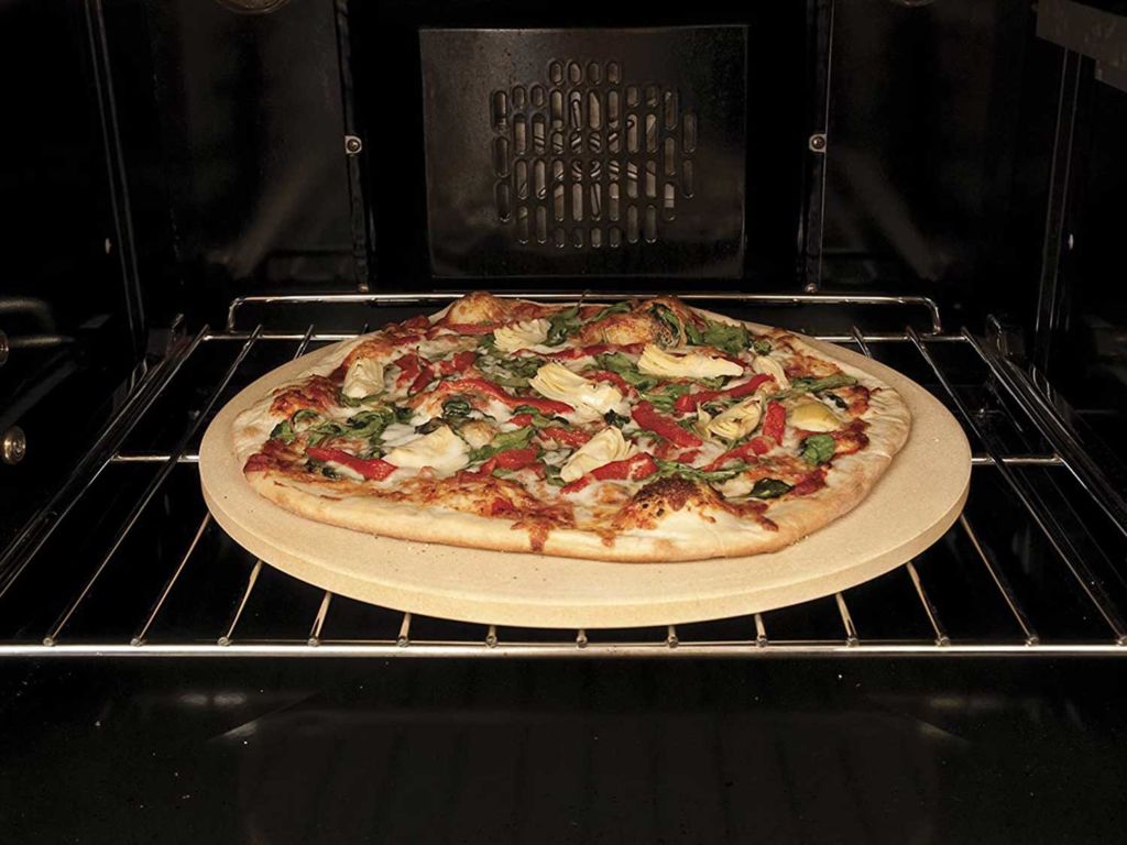 Pizza on a pizza stone in the oven