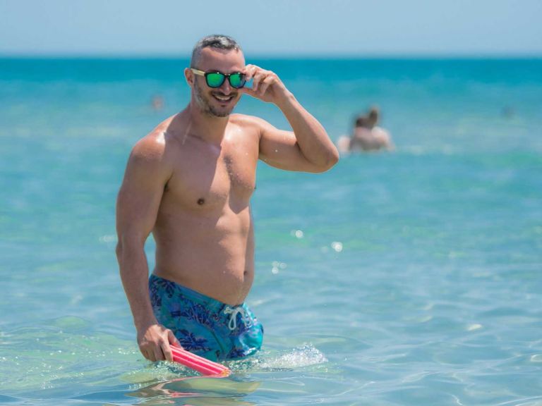 Man wearing a swim suit in the water.