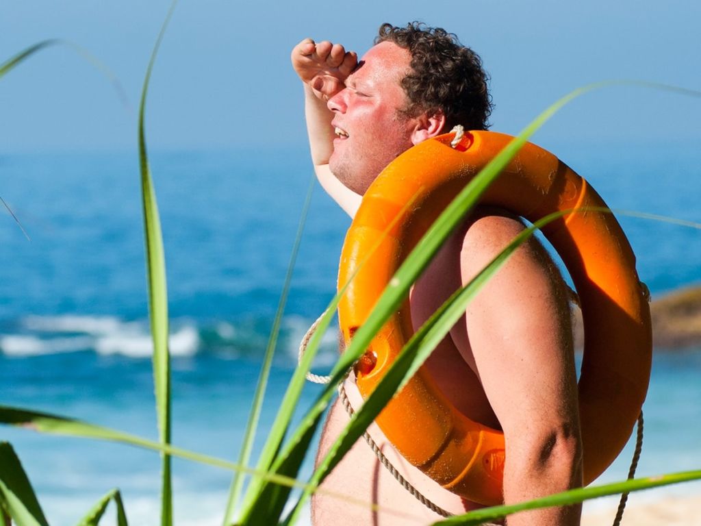 Guy on the beach getting sunburned