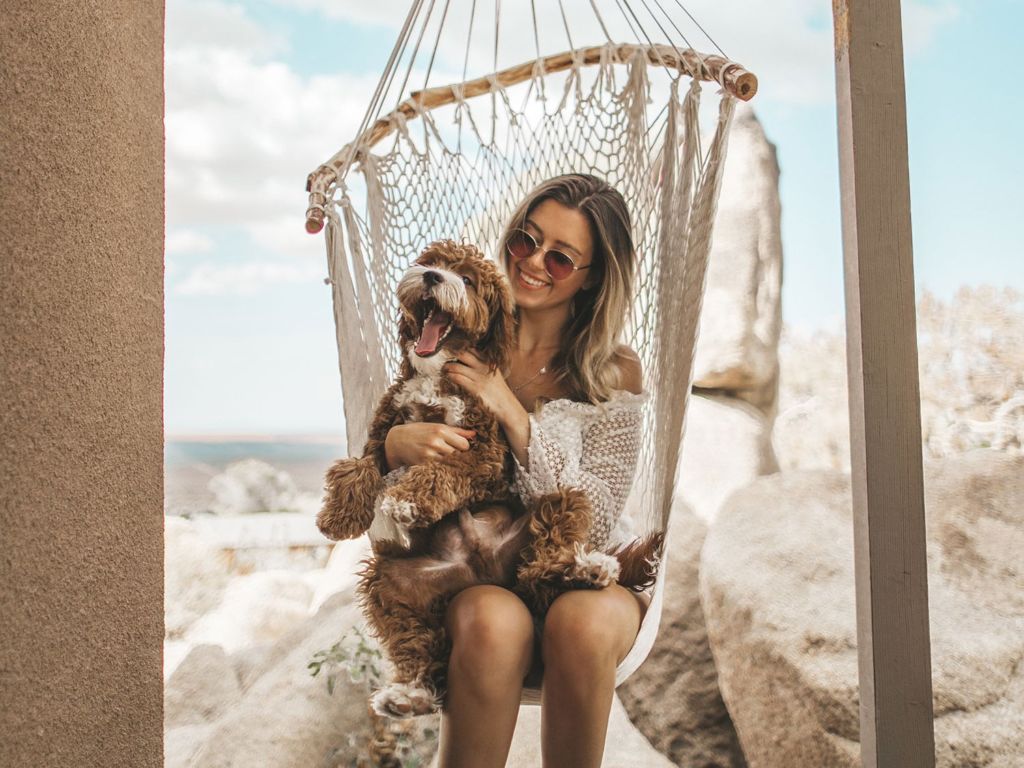 Woman and dog on a porch swing