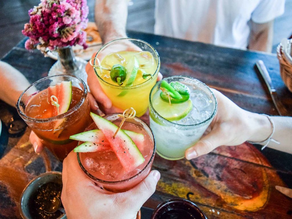 Group of people toasting with drinks