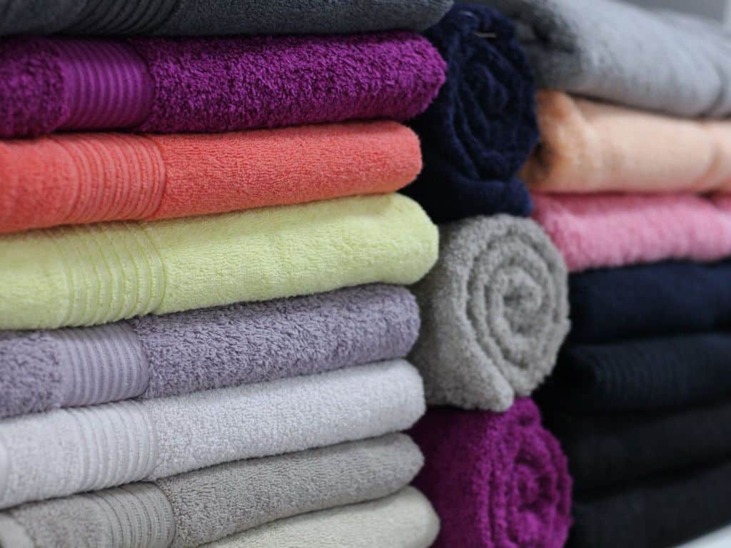 Different colored bath towels stacked together.