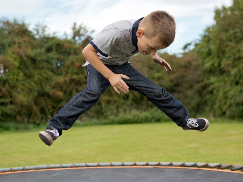 Boy bouncing on trampoline