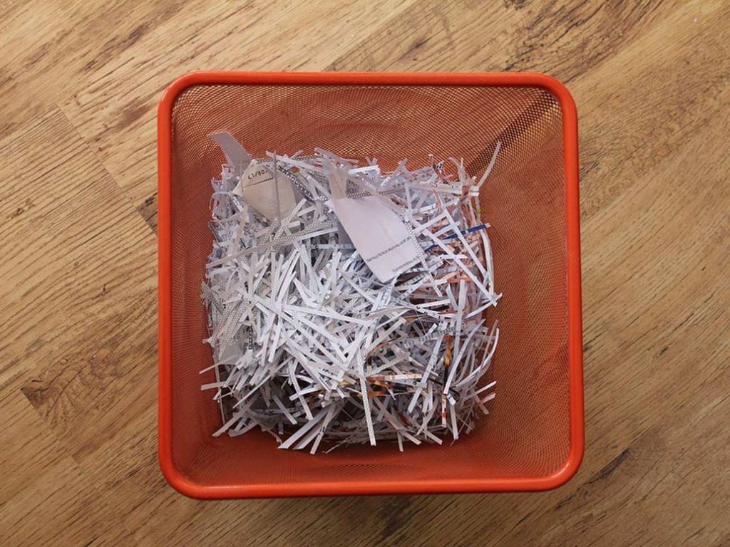 Shredded paper in a waste basket.