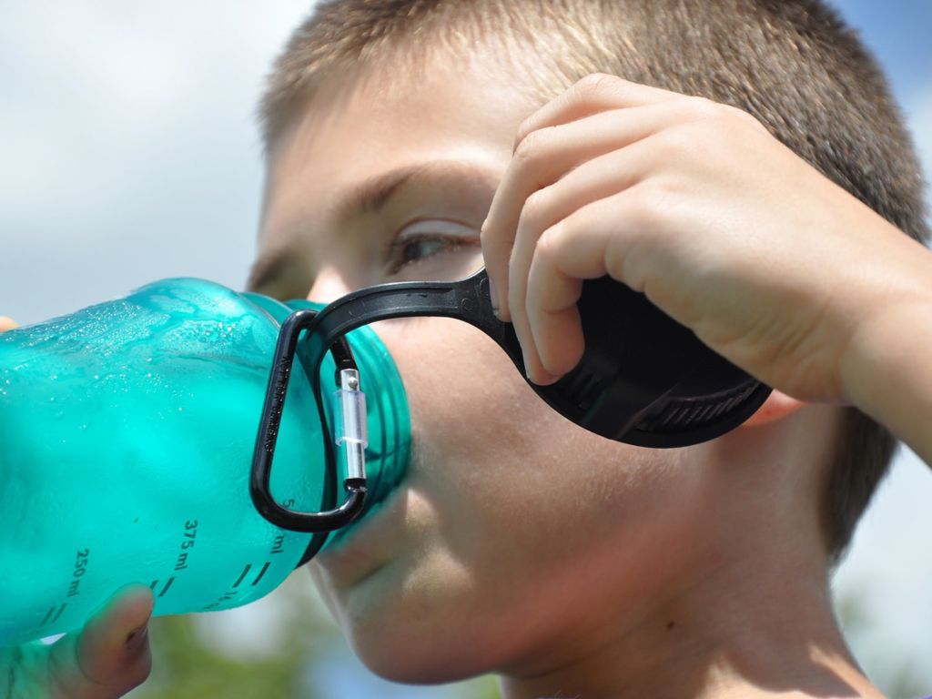 Boy drinking from a water bottle