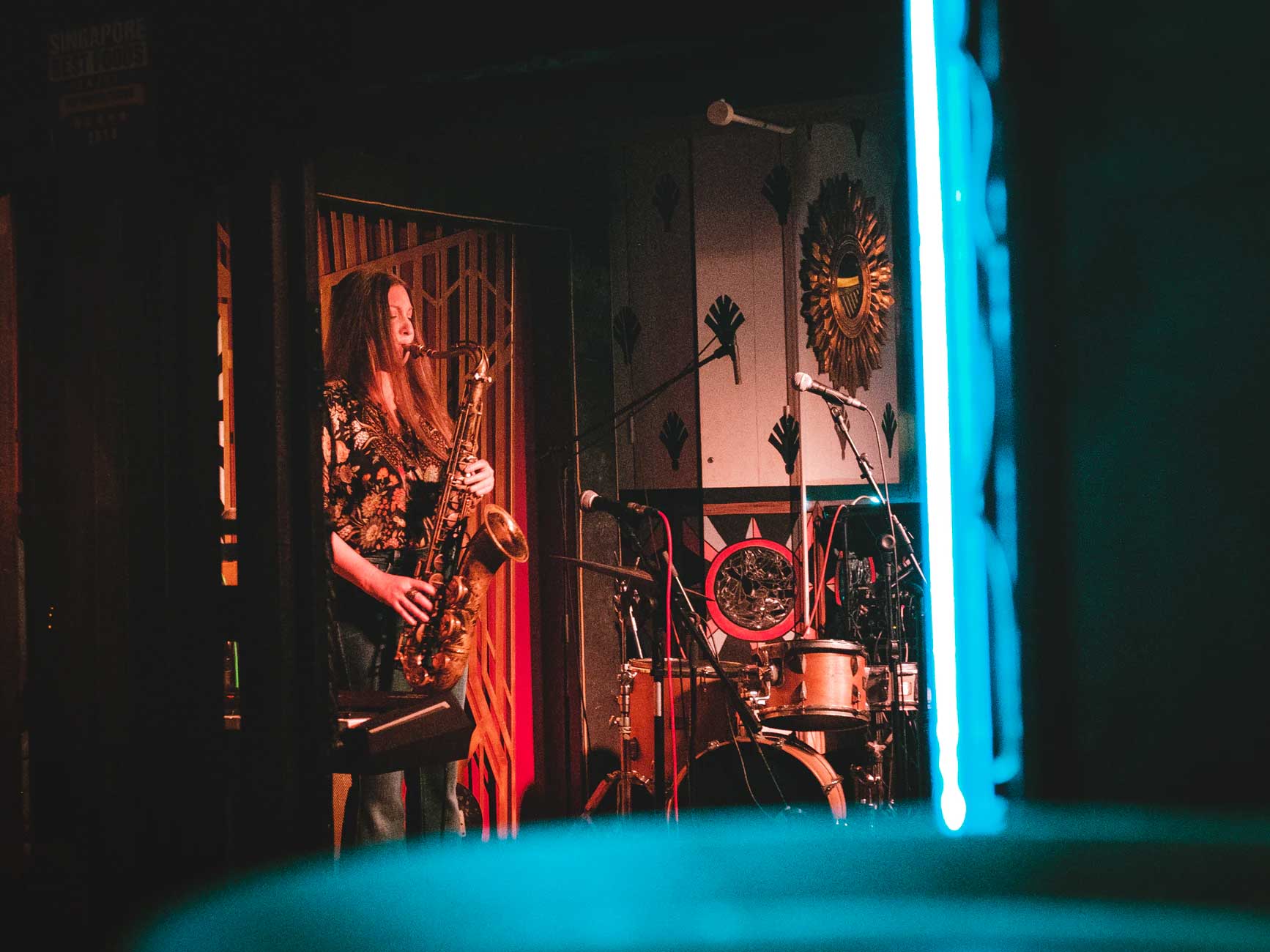 Woman playing saxophone in a nightclub