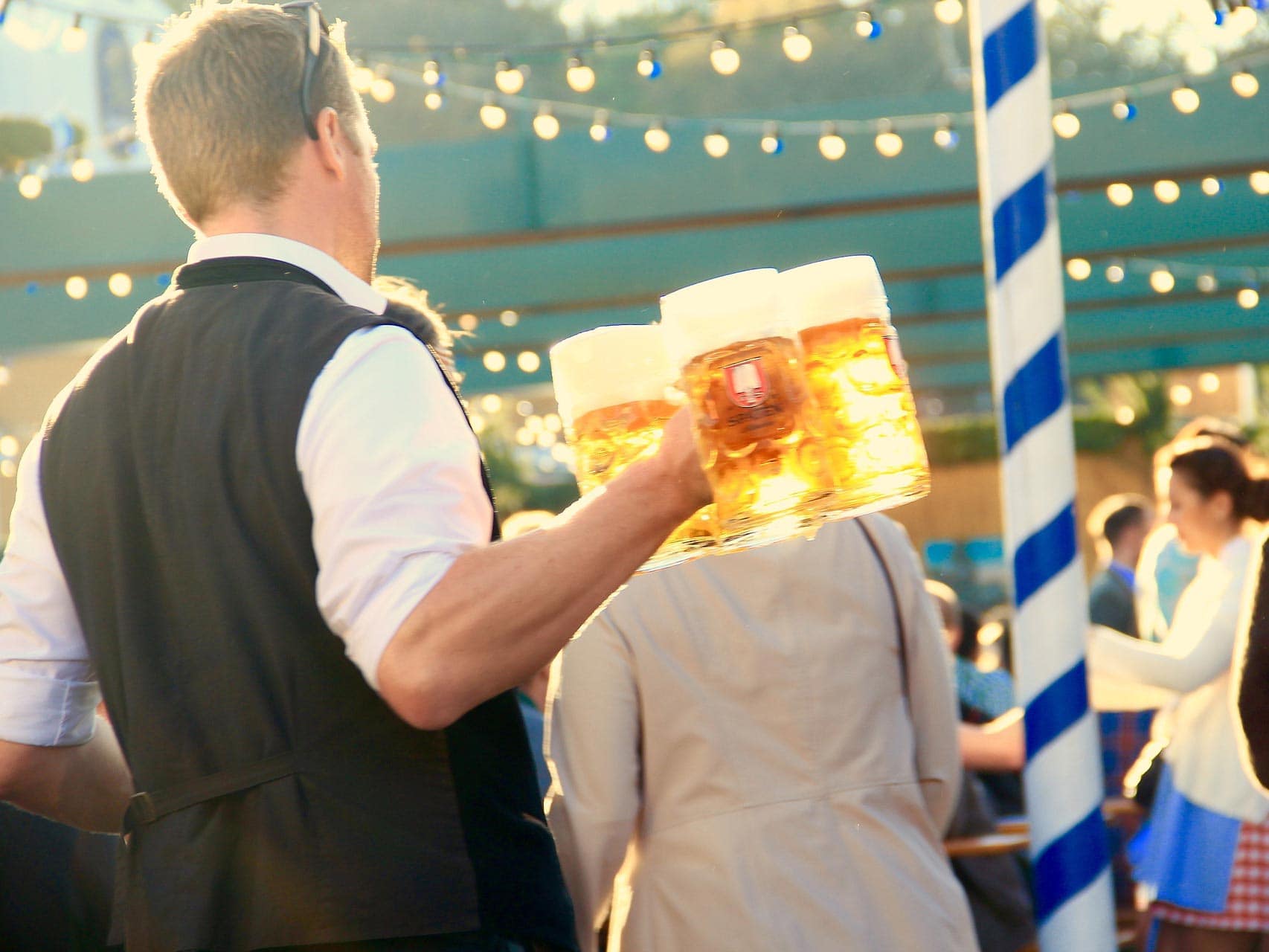 man holding three beers