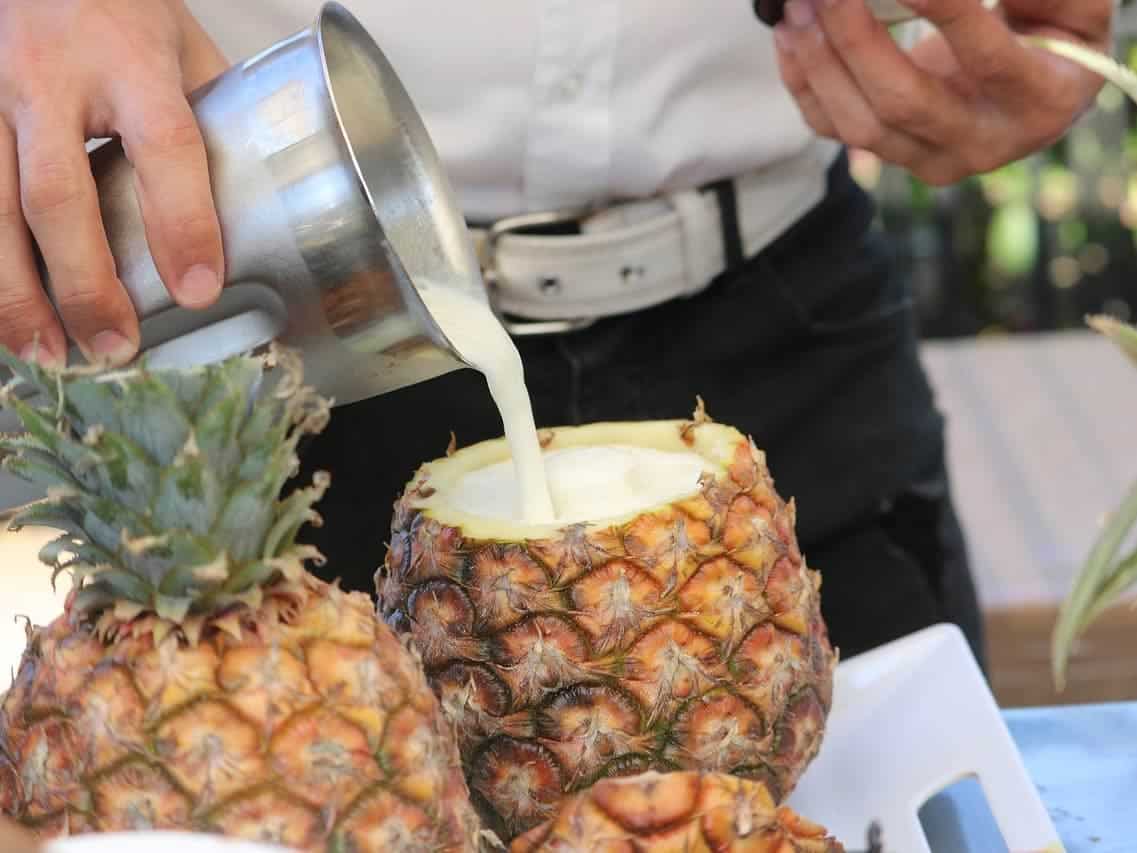 man making pina colada