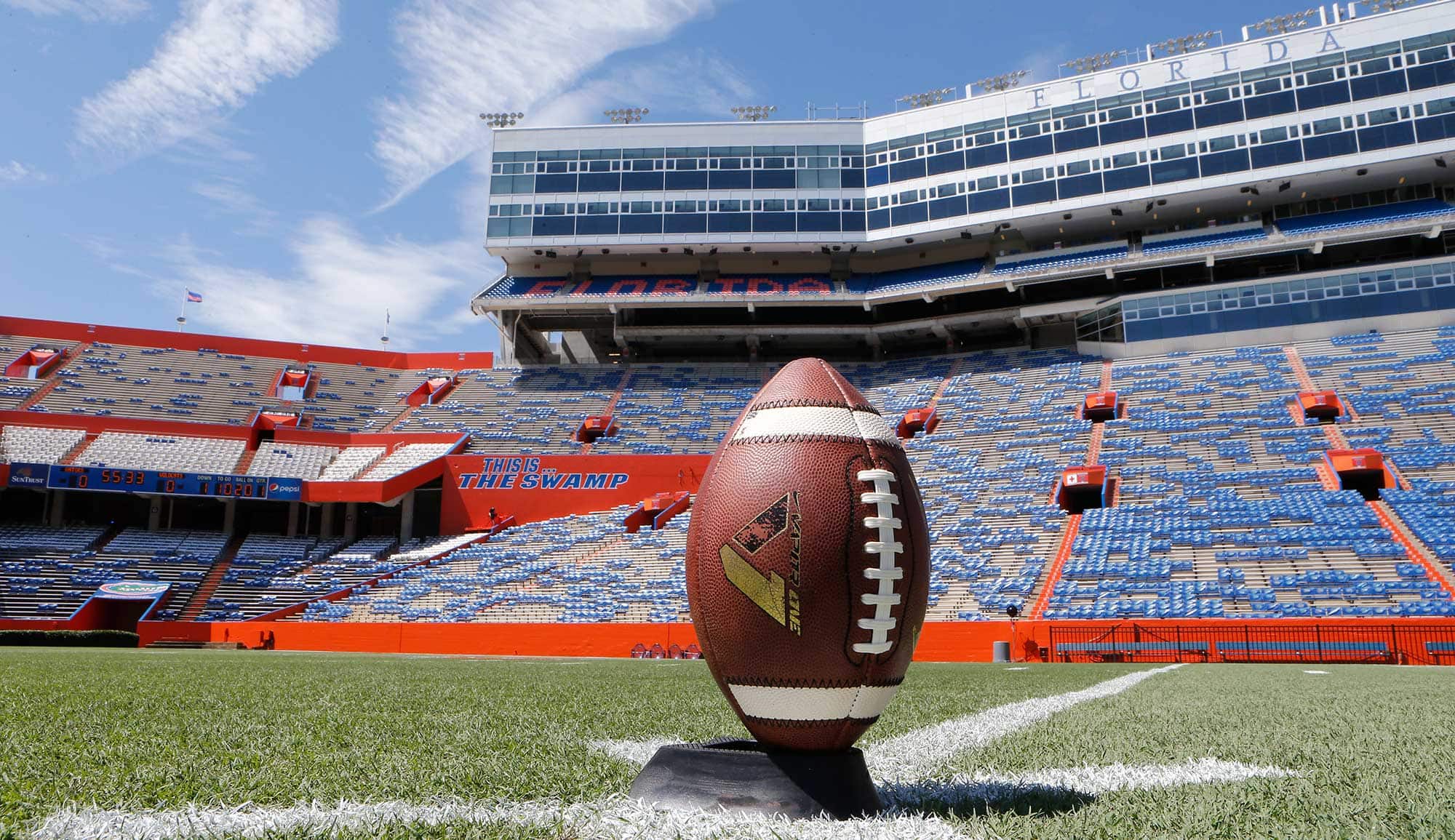 A football on a stand in a stadium.