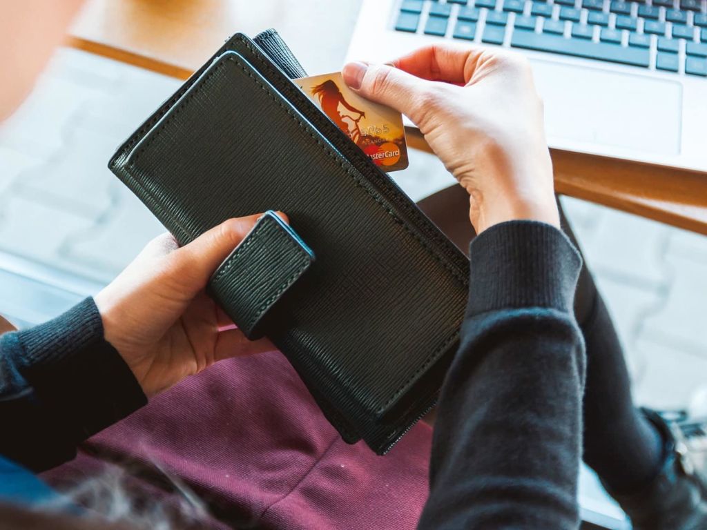 Woman putting credit card in wallet