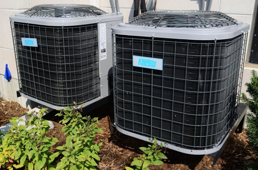 Two air conditioner units outside of a building.