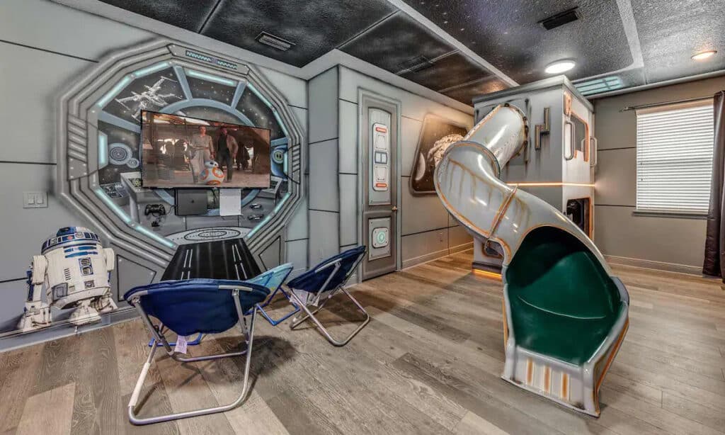 A Star Wars themed bedroom complete with a starship viewing port and a slide.