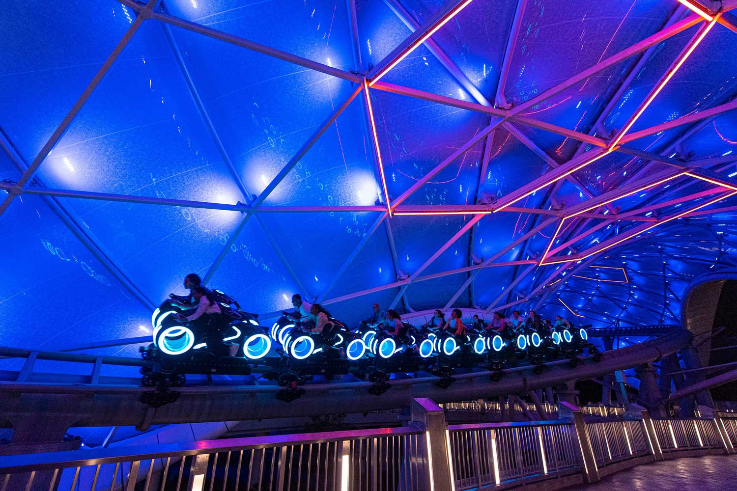 Riders travel through the Grid on the TRON coaster in Disney World.