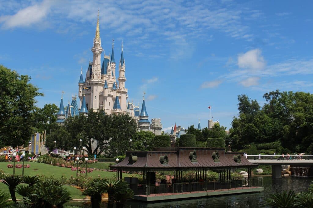 A photograph of Walt Disney World's Cinderella castle, overlooking the main entrance.