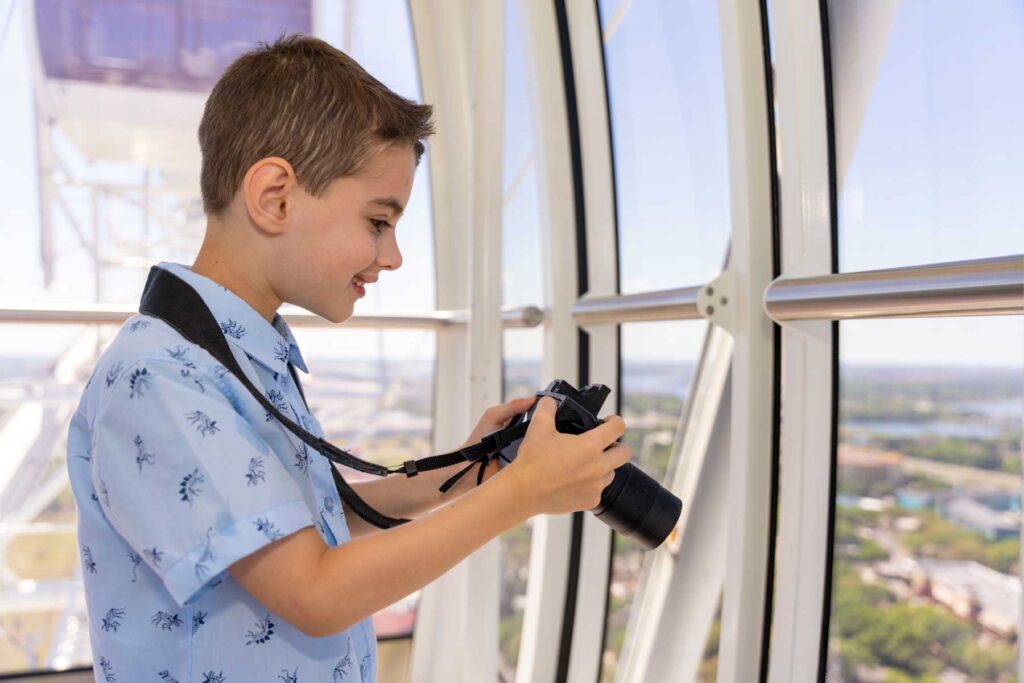 Boy holds camera inside The Wheel